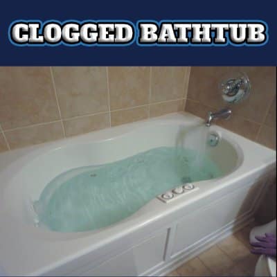 clogged bathtub in battle creek full of water